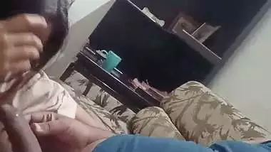The lady gives a desi blowjob to the man on the couch